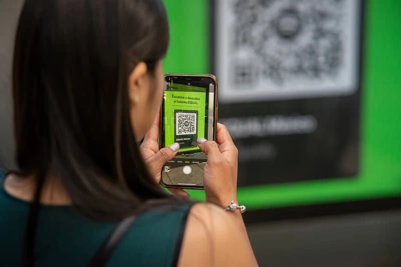 A woman scanning a QR code with her smartphone
