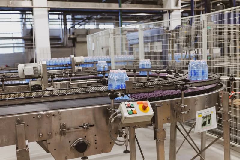 Bottles moving along an automated conveyor in a factory