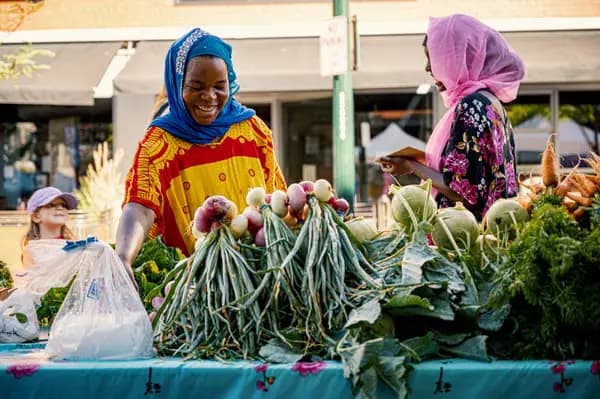Vendor and customer at a fresh produce market