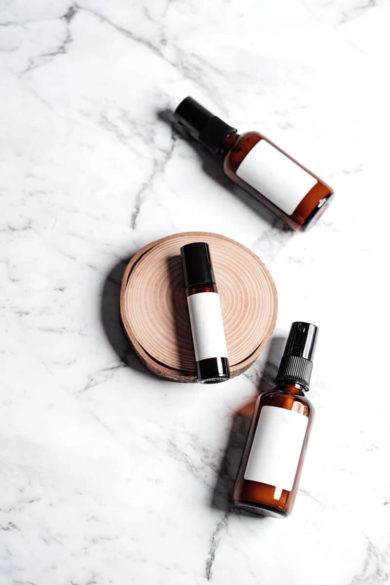 Amber skincare bottles on a marble surface
