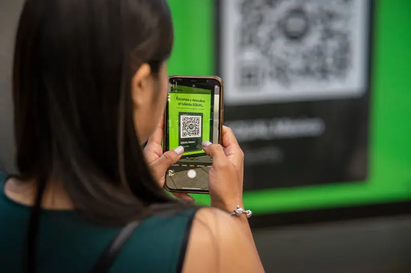 A shopper scanning a product QR code with a smartphone